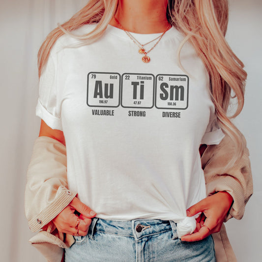 a woman wearing a white t - shirt with the words au tism on it