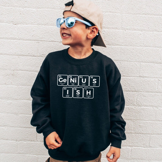 a young boy wearing a black sweatshirt with the words genius on it