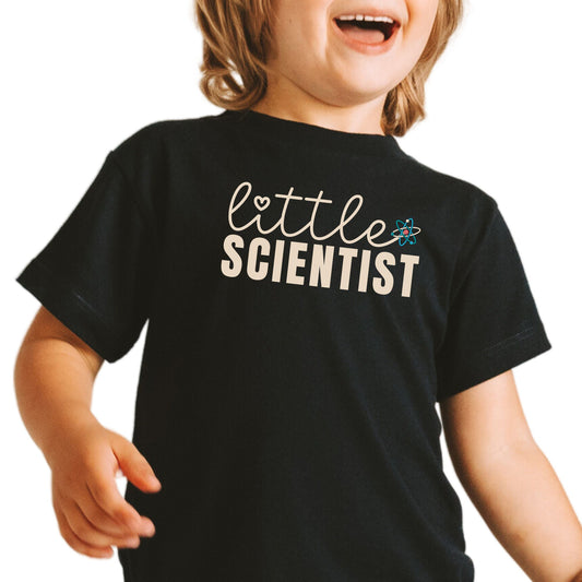 a little boy that is standing up with a smile on his face