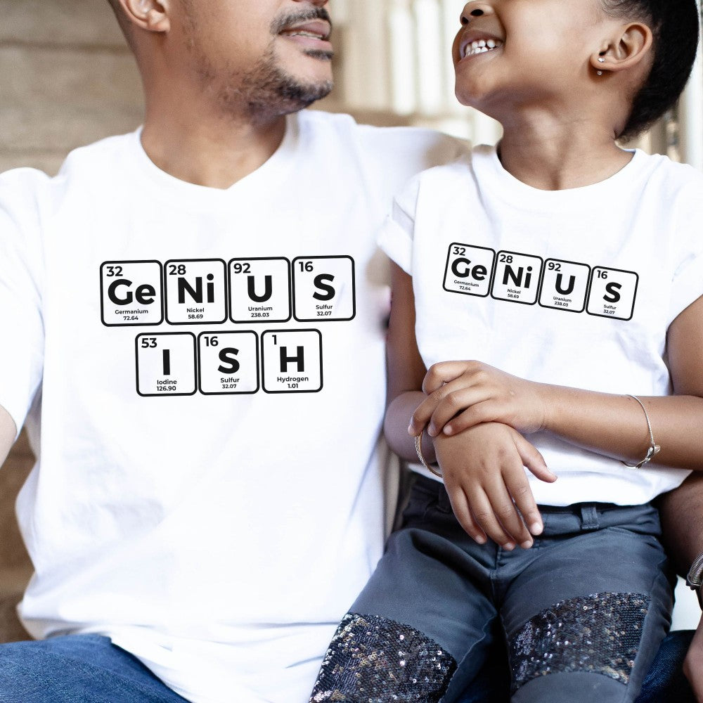 a man and a little girl sitting next to each other