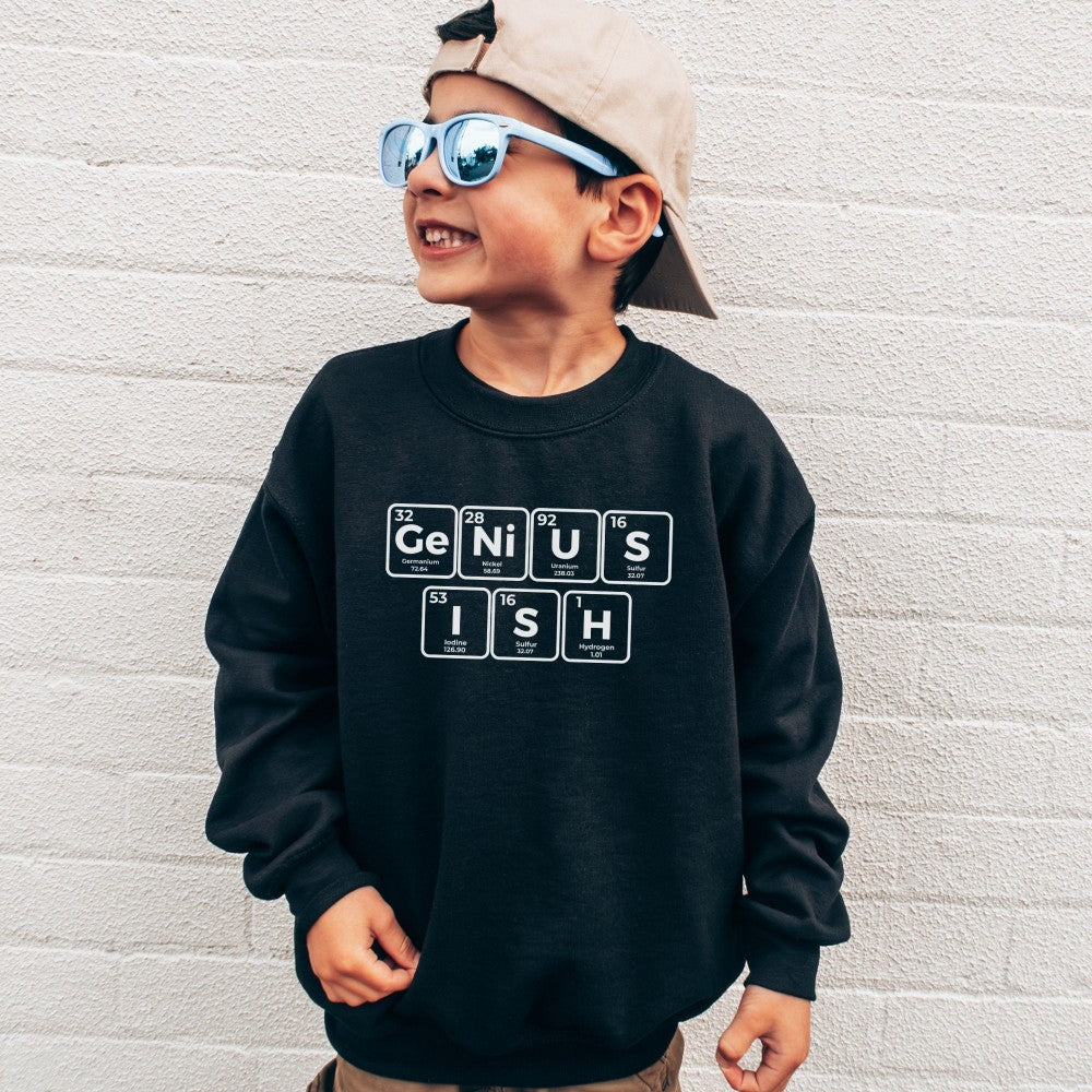 a young boy wearing a black sweatshirt with the words genius on it