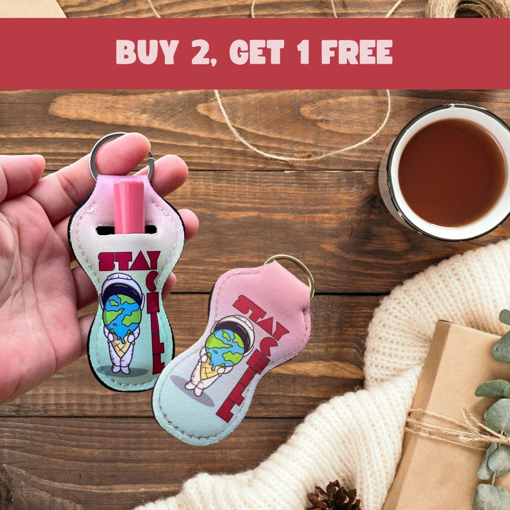 a person holding a pair of shoes shaped keychains