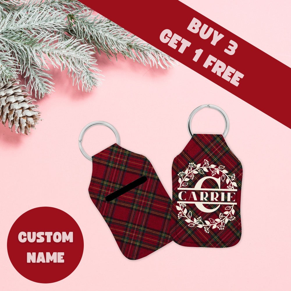 a pair of red and black plaid luggage tags next to a pine tree