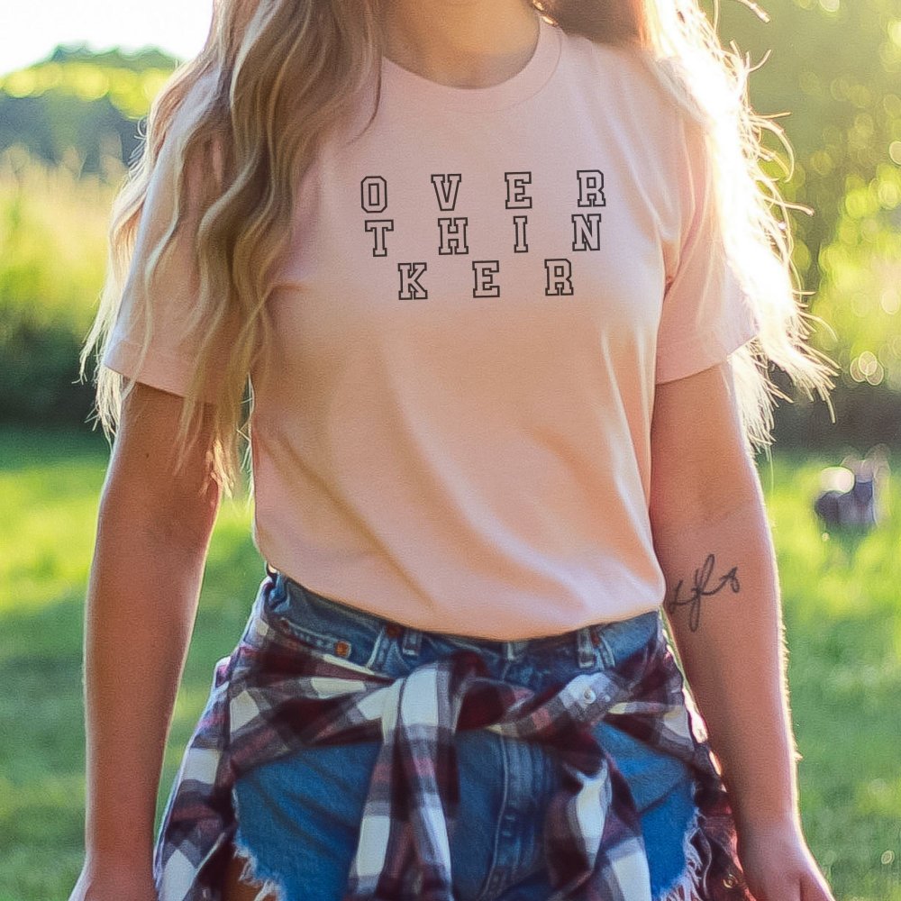 a woman with a pink shirt and plaid skirt