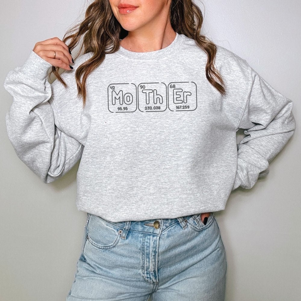 a woman wearing a sweatshirt with the word mother on it