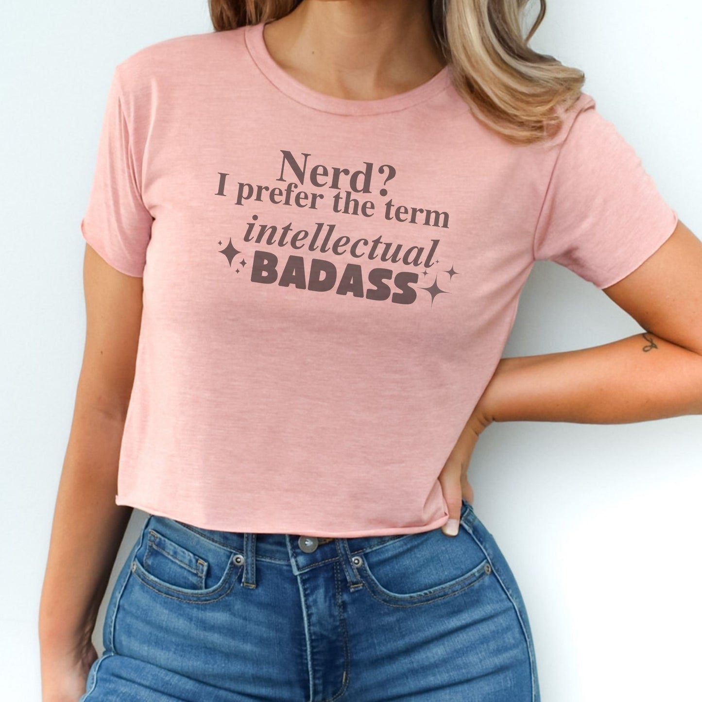 a woman wearing a pink shirt that says, nerd? i prefer the term