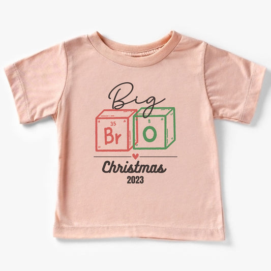 a pink t - shirt with a christmas design on it