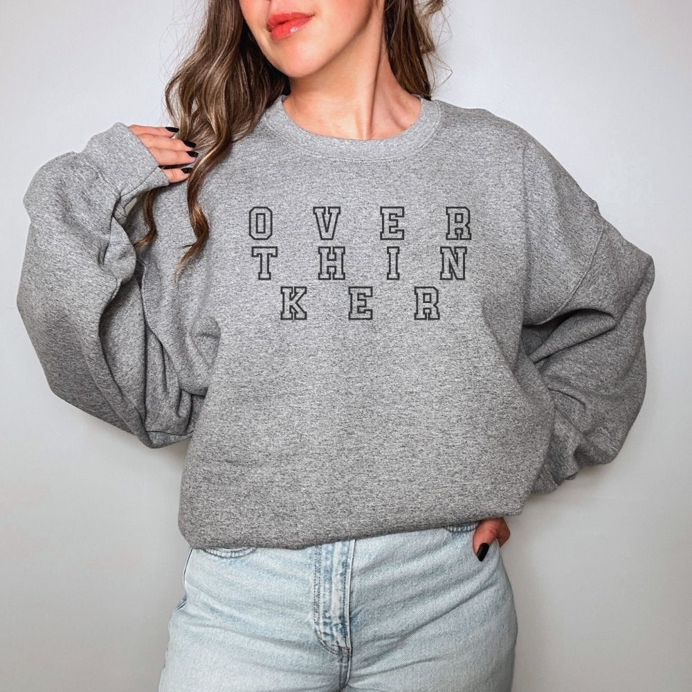 a woman wearing a sweatshirt that says over the knee