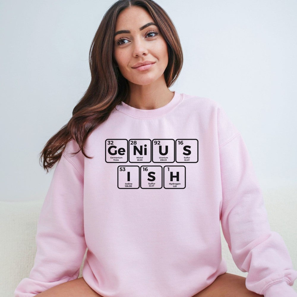 a woman sitting on a couch wearing a pink sweatshirt