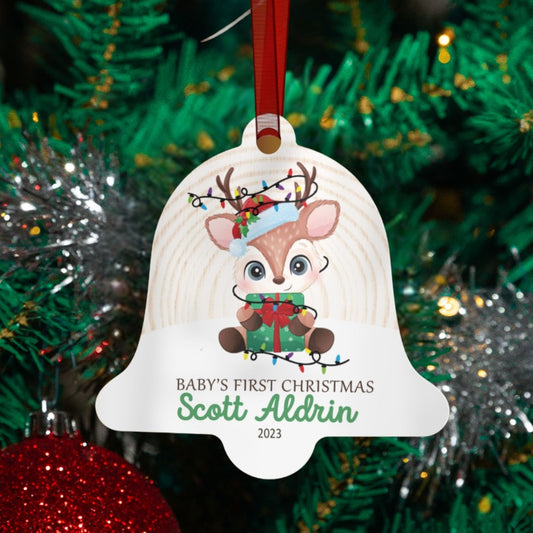 a baby's first christmas ornament hanging from a christmas tree