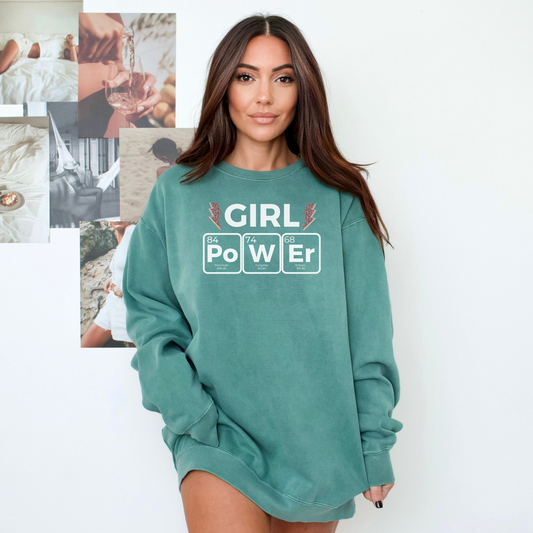 a woman wearing a green sweatshirt that says girl power