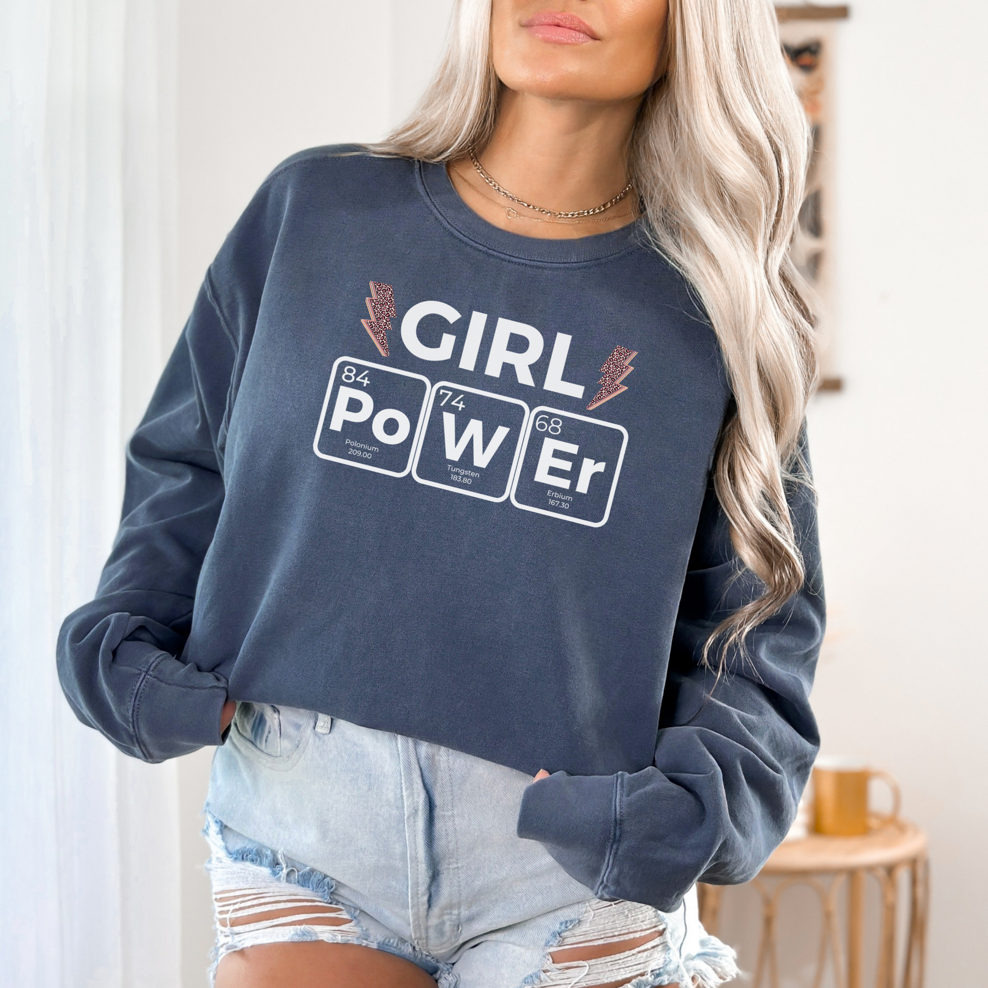 a woman wearing a sweatshirt that says girl power