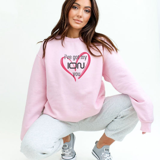 a woman in a pink sweatshirt with a heart on it